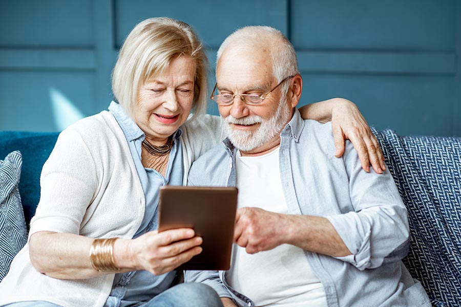 Blog - Senior Couple Use a Tablet on the Couch Together