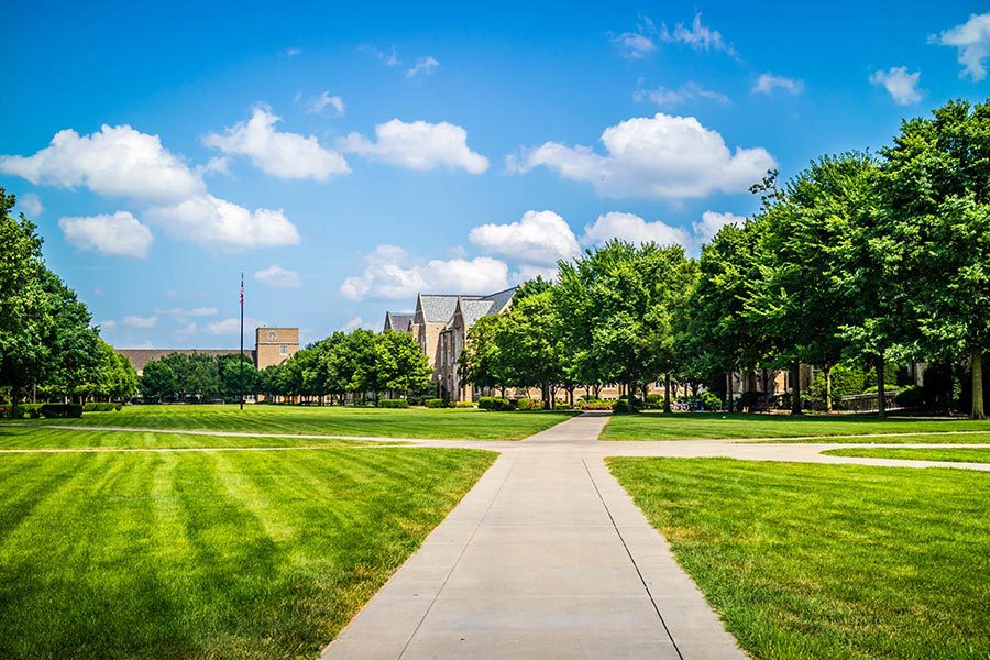 South Bend, IN Insurance - Beautiful Summer Day on the Notre Dame Campus, a Walking Path, Trees and Grassy Areas